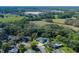 Aerial view of property with a large yard, screened pool, and mature trees at 3609 Montclair Dr, New Port Richey, FL 34655