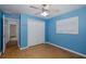 This bedroom features wood floors, light blue walls, a window and a ceiling fan at 3609 Montclair Dr, New Port Richey, FL 34655