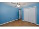This bedroom has wood floors, light blue walls, and a closet at 3609 Montclair Dr, New Port Richey, FL 34655