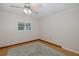 This is a cozy bedroom with a large window, ceiling fan, and hard wood floors at 3609 Montclair Dr, New Port Richey, FL 34655