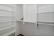 Walk-in closet with lots of shelves and storage with a light colored wooden floor at 3609 Montclair Dr, New Port Richey, FL 34655