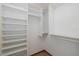 Walk-in closet with lots of shelves and storage with a dark colored tile floor at 3609 Montclair Dr, New Port Richey, FL 34655