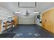 A well-lit garage featuring built-in storage cabinets and room for multiple vehicles at 3609 Montclair Dr, New Port Richey, FL 34655