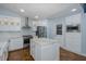 Modern kitchen with white cabinets, stainless steel appliances, and a center island perfect for cooking at 3609 Montclair Dr, New Port Richey, FL 34655