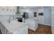 Modern white kitchen with stainless steel appliances, granite countertops, and ample cabinet space at 3609 Montclair Dr, New Port Richey, FL 34655