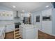 Modern kitchen featuring white cabinets, stainless steel appliances, and a functional center island with drawers at 3609 Montclair Dr, New Port Richey, FL 34655