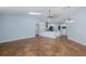 Spacious living room with tile floors, ceiling fan, and open floor plan connected to kitchen at 3609 Montclair Dr, New Port Richey, FL 34655