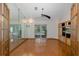 Spacious room with hardwood floors, entertainment center, and sliding doors to a screened lanai at 3609 Montclair Dr, New Port Richey, FL 34655