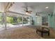 Covered patio featuring brick flooring, two fans, and scenic pool view beyond the screen at 3609 Montclair Dr, New Port Richey, FL 34655