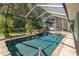Sparkling screened-in pool with rock waterfall and lush landscaping for ultimate relaxation at 3609 Montclair Dr, New Port Richey, FL 34655