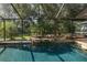 Enjoy the backyard views from the sparkling screened-in pool with rock features at 3609 Montclair Dr, New Port Richey, FL 34655