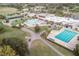 Aerial view of community featuring a community pool, clubhouse, parking area, and common area at 3627 Muirfield Ct # 3627, New Port Richey, FL 34655