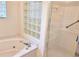 Bathroom featuring a soaking tub, glass block window, and separate shower at 3627 Muirfield Ct # 3627, New Port Richey, FL 34655