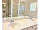 Bright bathroom featuring double sinks, large mirror, and glass enclosed shower at 3627 Muirfield Ct # 3627, New Port Richey, FL 34655