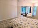 Cozy bedroom featuring plush carpeting, chair, and view into the lanai at 3627 Muirfield Ct # 3627, New Port Richey, FL 34655