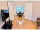 Open dining room with ample natural light, offering a view of a well-lit meeting space beyond double doors at 3627 Muirfield Ct # 3627, New Port Richey, FL 34655