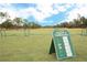 View of driving range with yardage sign visible to show distances of each target on the golf field at 3627 Muirfield Ct # 3627, New Port Richey, FL 34655