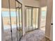Hallway with mirrored closet doors leading to the bathroom, tub, and toilet at 3627 Muirfield Ct # 3627, New Port Richey, FL 34655
