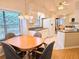 Eat-in kitchen area with wood floors, granite countertops, white cabinetry, and a sunlit window at 3627 Muirfield Ct # 3627, New Port Richey, FL 34655