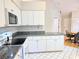 Bright kitchen with granite countertops, white cabinetry, and modern appliances at 3627 Muirfield Ct # 3627, New Port Richey, FL 34655