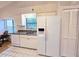 Bright kitchen with granite counters, a white refrigerator and appliances, and tile flooring at 3627 Muirfield Ct # 3627, New Port Richey, FL 34655