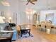 Spacious living room with hardwood floors, vaulted ceiling, and combined dining area with chandelier at 3627 Muirfield Ct # 3627, New Port Richey, FL 34655