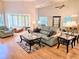 Elegant living room with comfortable seating, large windows, and mirrored wall accents at 3627 Muirfield Ct # 3627, New Port Richey, FL 34655
