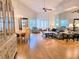 A bright living room features hardwood floors, vaulted ceilings, and a combined dining area at 3627 Muirfield Ct # 3627, New Port Richey, FL 34655