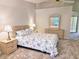Serene main bedroom with plush carpeting, dresser, and bedside tables at 3627 Muirfield Ct # 3627, New Port Richey, FL 34655