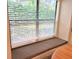 A cozy window seat with striped cushion offers a sunny nook with views of the outdoors at 3627 Muirfield Ct # 3627, New Port Richey, FL 34655