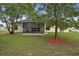 The home's private backyard features a screened lanai and mature landscaping for relaxation at 3631 Celebration Dr, Brooksville, FL 34604