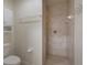 Bathroom featuring a walk-in shower with tile walls and a convenient toilet at 3631 Celebration Dr, Brooksville, FL 34604