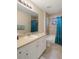 Bathroom featuring a vanity, framed mirror, tiled shower with tub, and soft natural light at 3631 Celebration Dr, Brooksville, FL 34604