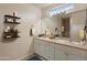 Bathroom featuring double sinks, a large mirror, and decorative shelves at 3631 Celebration Dr, Brooksville, FL 34604