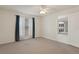 Light-filled bedroom features a window with curtains and a view of the backyard at 3631 Celebration Dr, Brooksville, FL 34604