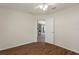 A bright bedroom with a ceiling fan, wood flooring, and an open doorway at 3631 Celebration Dr, Brooksville, FL 34604