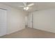 Bedroom with carpet flooring, ceiling fan, closet with folding doors, and open doorway at 3631 Celebration Dr, Brooksville, FL 34604