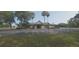 Community clubhouse and parking area with accessible parking spaces and mature landscaping on a sunny day at 3631 Celebration Dr, Brooksville, FL 34604
