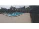 Rectangular community swimming pool surrounded by fencing and a concrete pool deck at 3631 Celebration Dr, Brooksville, FL 34604