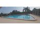 Community pool with fence and covered seating area at 3631 Celebration Dr, Brooksville, FL 34604