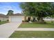Well-maintained home with a two-car garage and a lush front yard at 3631 Celebration Dr, Brooksville, FL 34604