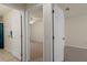 Hallway with open doors leads to bedroom and bathroom; carpet and tile flooring at 3631 Celebration Dr, Brooksville, FL 34604
