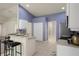 Open kitchen area featuring tile flooring, breakfast bar, and stainless steel appliances at 3631 Celebration Dr, Brooksville, FL 34604