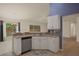 Cozy kitchen with stainless steel dishwasher, breakfast bar, and views to the backyard at 3631 Celebration Dr, Brooksville, FL 34604