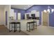 Open kitchen with barstool seating, white cabinets, and stainless steel appliances at 3631 Celebration Dr, Brooksville, FL 34604