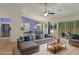 Staged living room with modern furnishings, bright colors, and an open floor plan at 3631 Celebration Dr, Brooksville, FL 34604