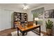 Staged office space with a large desk, bookcase, and natural lighting at 3631 Celebration Dr, Brooksville, FL 34604