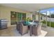Covered patio with an outdoor dining set and a stainless steel grill at 3631 Celebration Dr, Brooksville, FL 34604