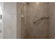Walk-in shower with tile walls and a shower head and grab bar at 3631 Celebration Dr, Brooksville, FL 34604