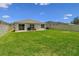 Lush backyard with healthy green grass, a patio, and fencing, perfect for relaxation and recreation at 3886 Reflection Dock Dr, Seffner, FL 33584